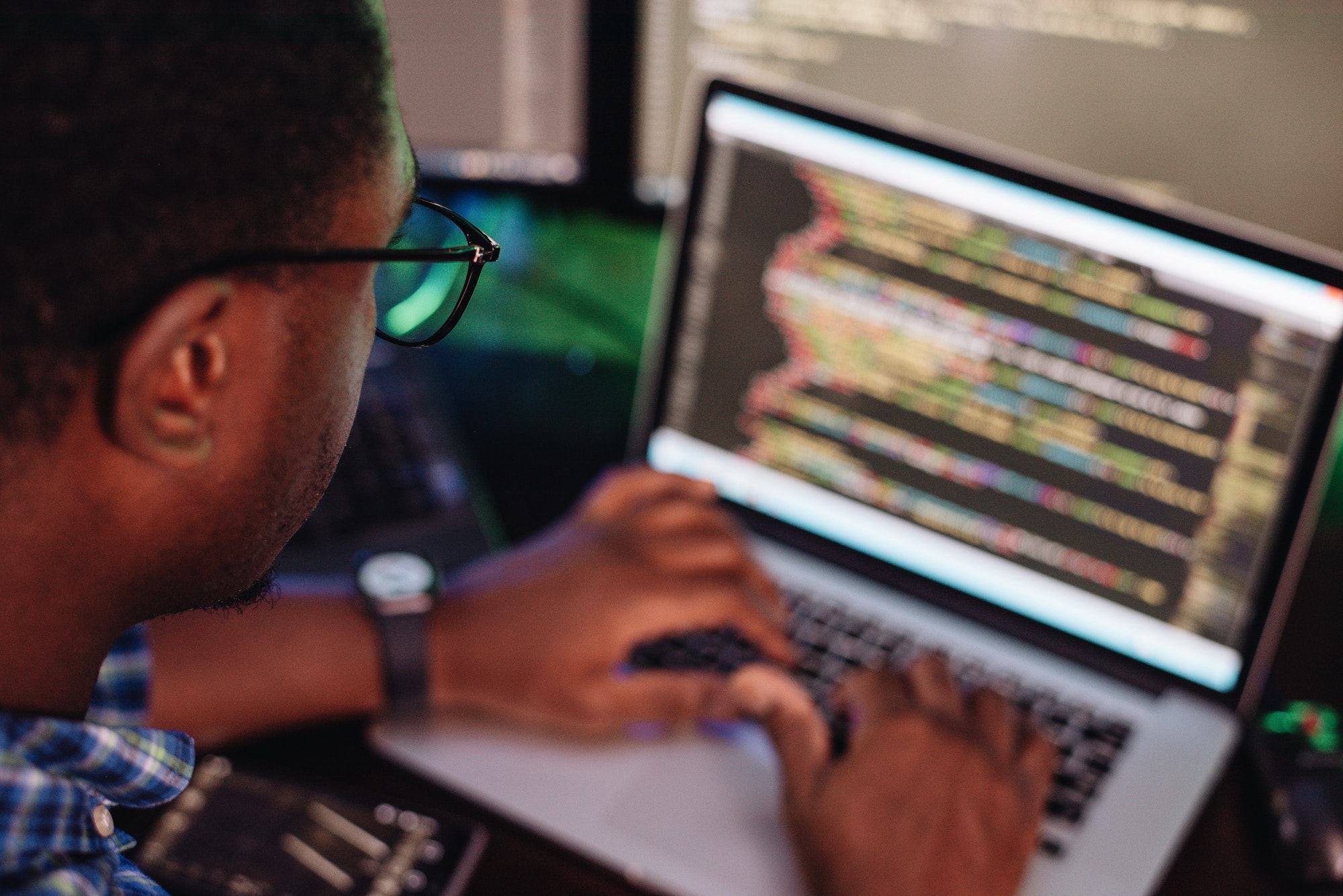 black-male-in-front-of-computer-screen-coding-mobile-app-web-development-computer-programming.jpg